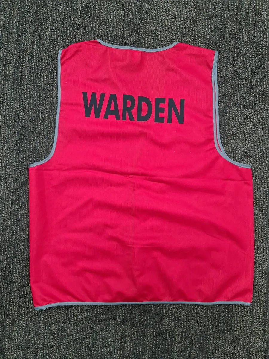 Red reflective safety vest for a Fire Warden, showing the back printed with "WARDEN" in black text.